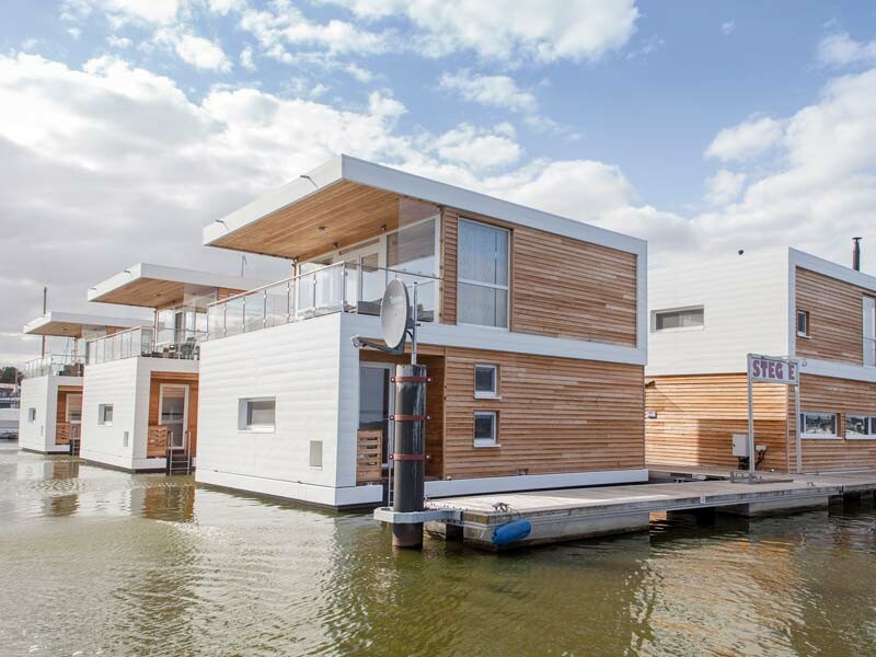 Häuser am Wasser verkleidet mit PREFA Aluminiumprodukten