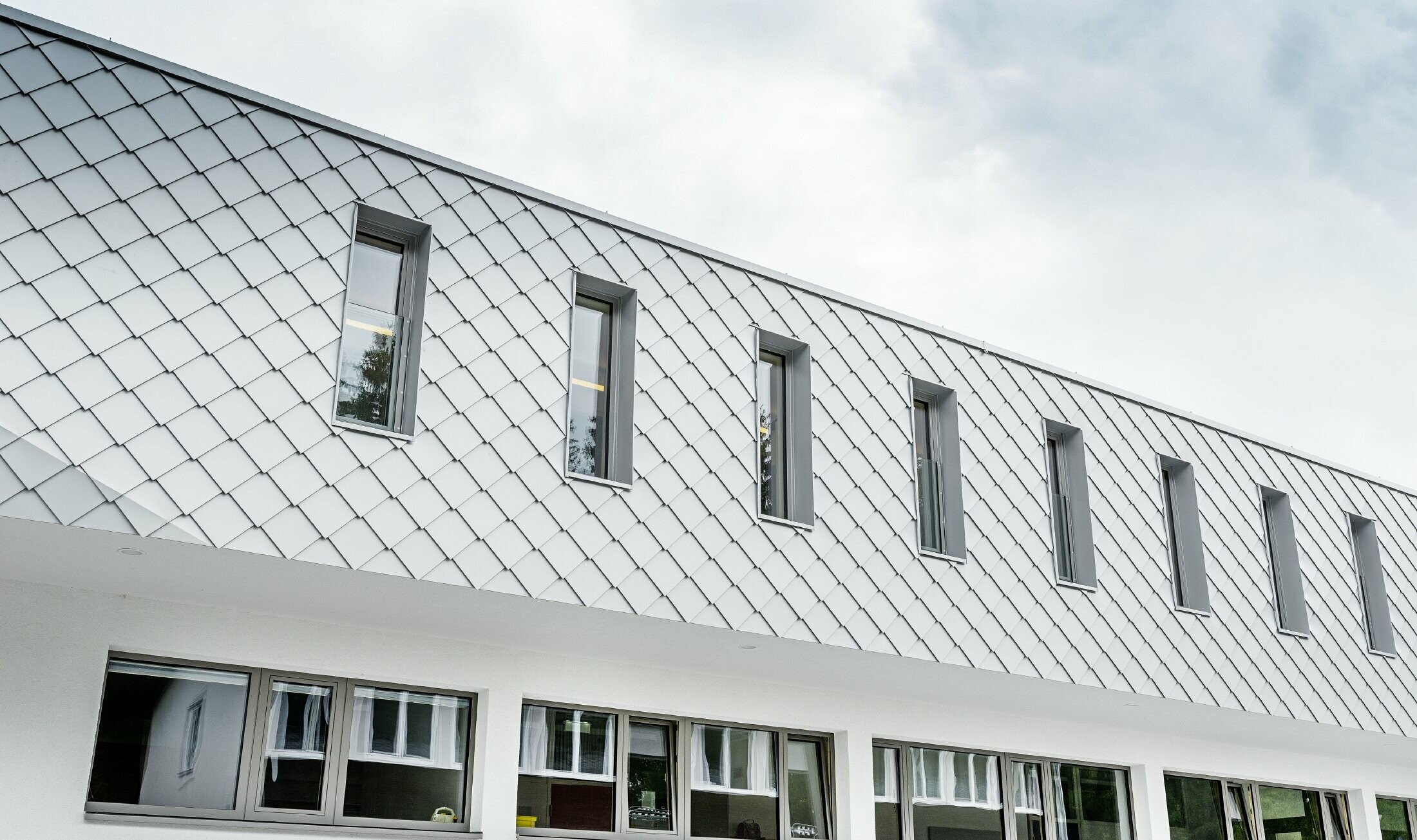 Pas gebouwde kleuterschool in Kaprun met een moderne aluminium gevel met PREFA gevellosanges in prefawit