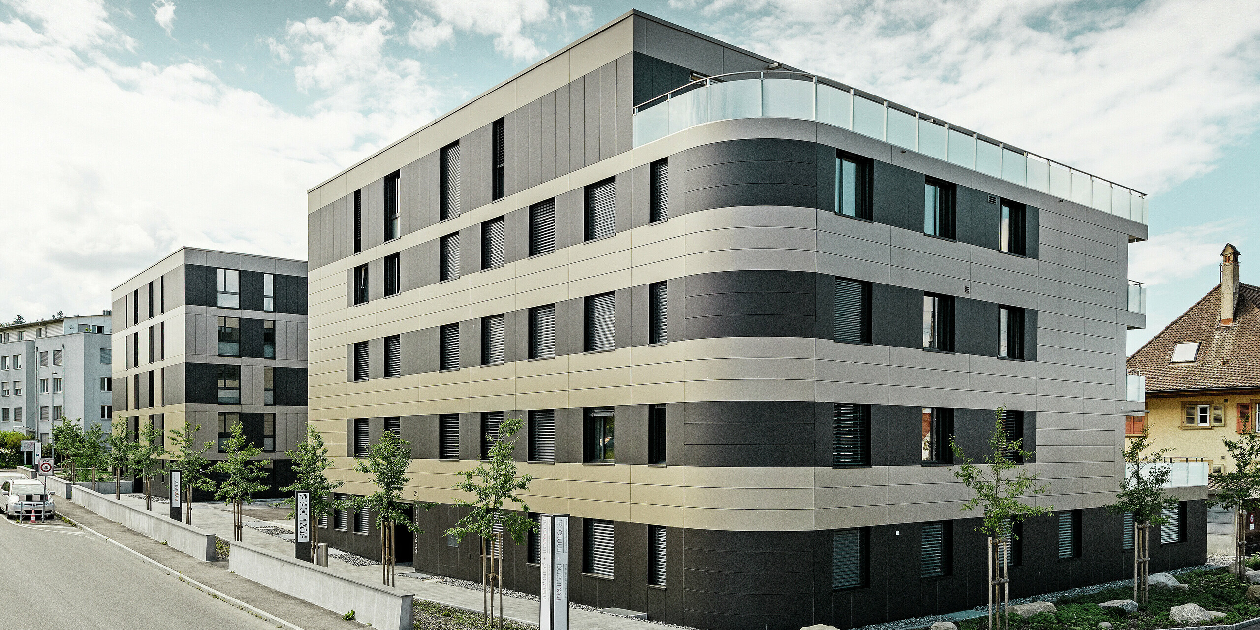 Kubusvormig woongebouw met aluminiumgevel in brons en zwartgrijze elementen